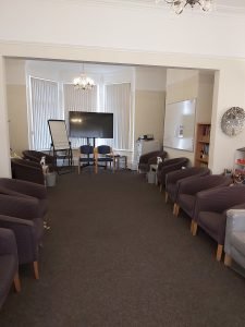 Training room on the ground floor of The Ellesmere Centre Holderness Road which is a large therapy training room suitable for groups. There are lots of chairs, a projector and white board.